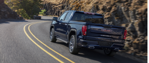 GMC Sierra azul en una carretera curva de montaña