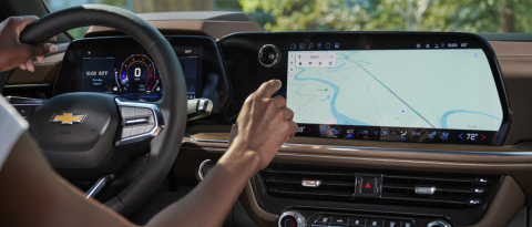 Parked driver preparing to delete GPS data from their vehicle.